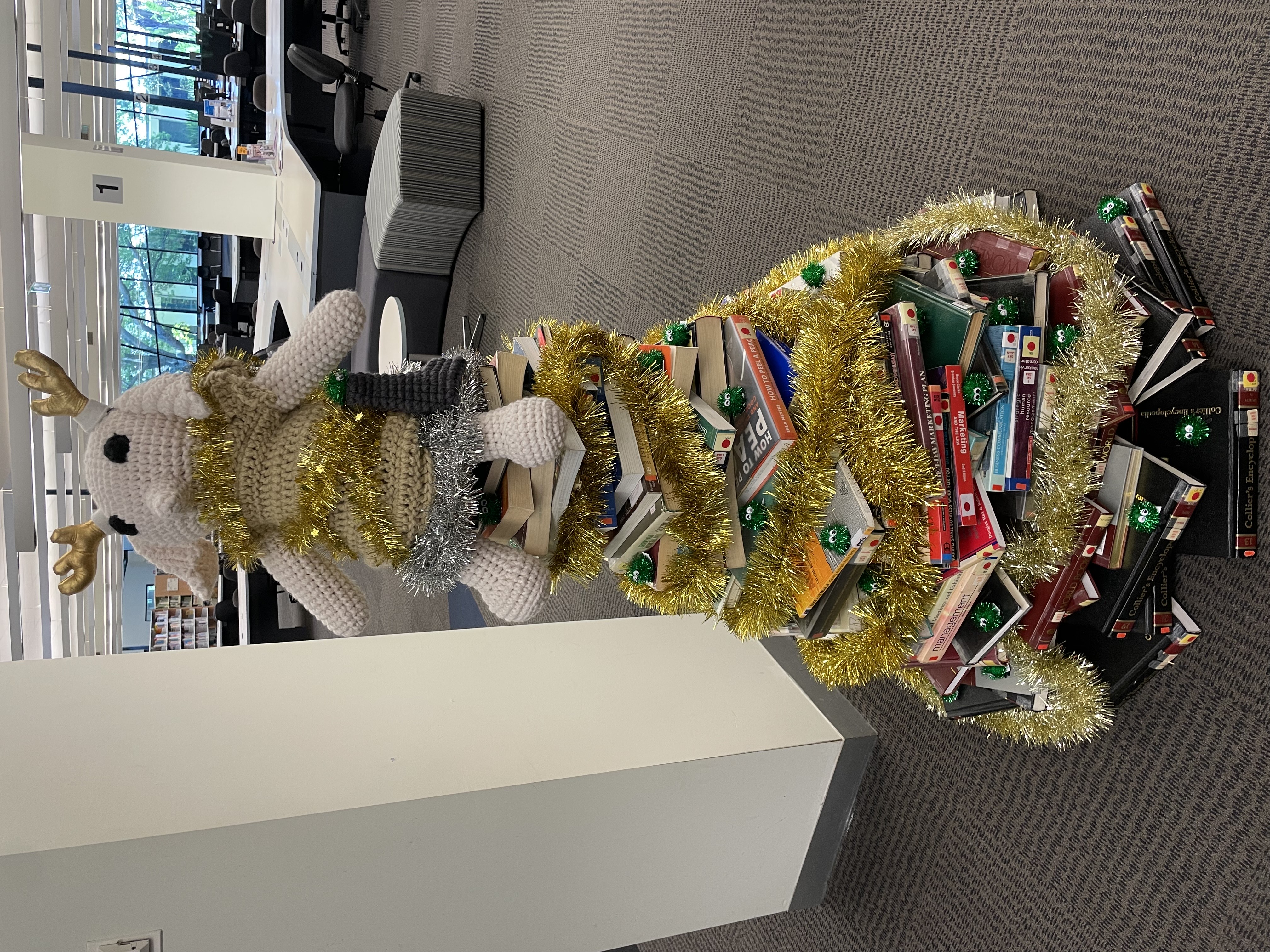 Christmas book tree with Dobby doll sitting at the top