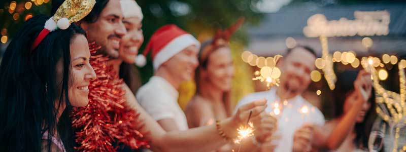 People celebrating summer and christmas with sparklers