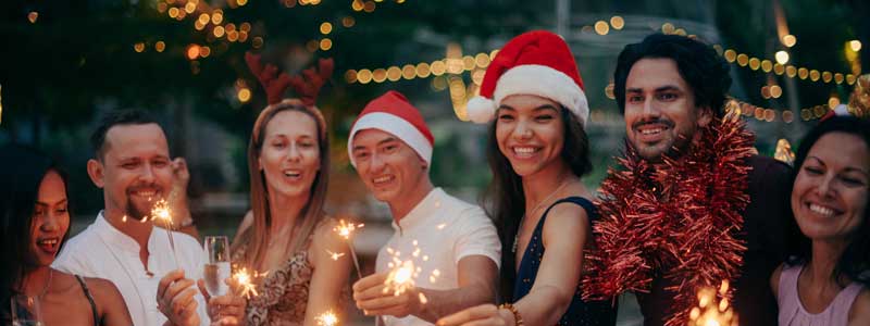 People celebrating summer and christmas with sparklers